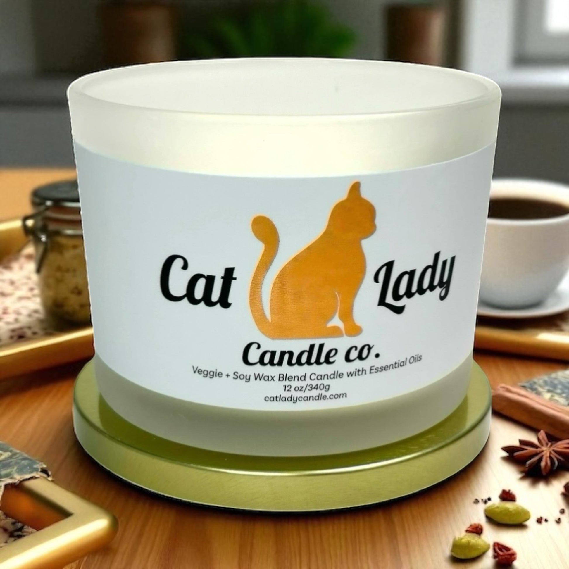Candle with 'Cat Lady Candle Co.' label candle on a wooden table surface with spice cloves and coffee in background