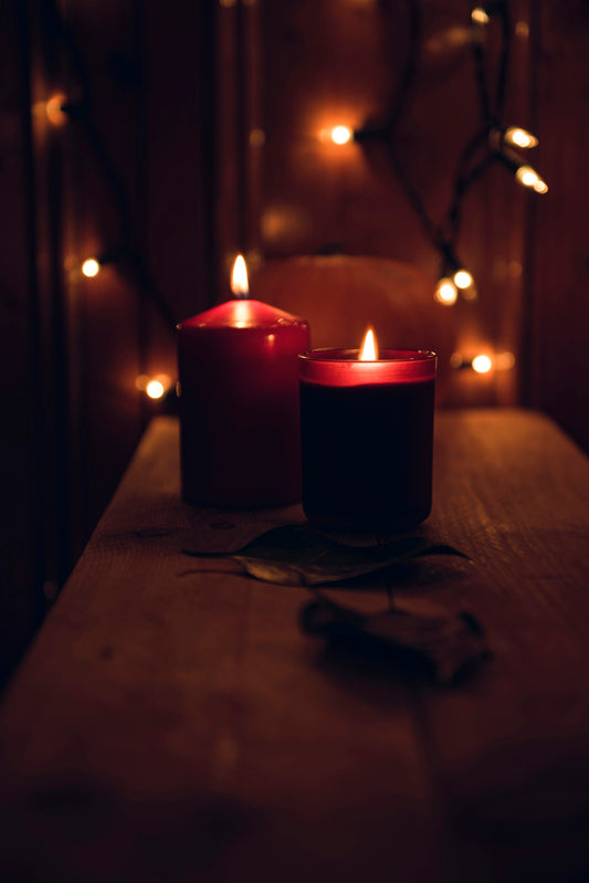 macro shot photography of two votive candles