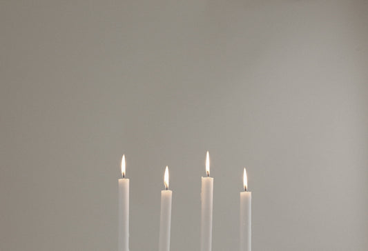 four lighted white candles