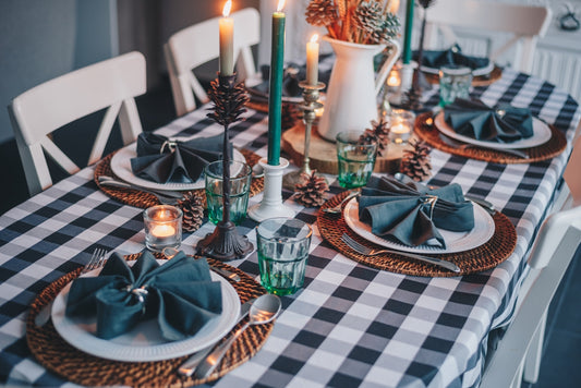 white candles on blue and white checkered table cloth